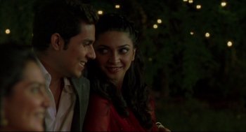 Movie still from “Monsoon Wedding” (2001), directed by Mira Nair – A man and a woman smiling for the camera; Close Up shot, Over the shoulder angle