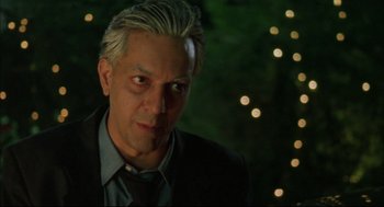Movie still from “Monsoon Wedding” (2001), directed by Mira Nair – A person wearing a suit and tie; Close Up shot, Over the shoulder angle