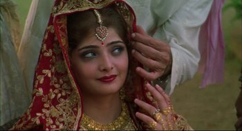 Movie still from “Monsoon Wedding” (2001), directed by Mira Nair – A beautiful woman wearing a red and gold headpiece; Close Up shot, Over the shoulder angle