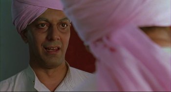 Movie still from “Monsoon Wedding” (2001), directed by Mira Nair – A person wearing a head covering; Close Up shot, Low angle
