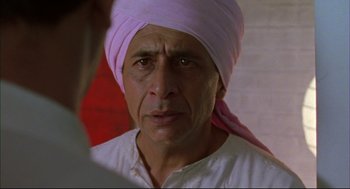 Movie still from “Monsoon Wedding” (2001), directed by Mira Nair – A person wearing a turban; Close Up shot, Over the shoulder angle