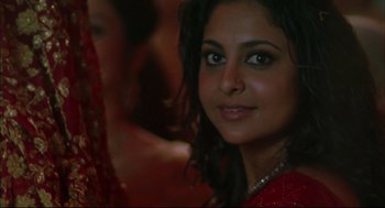 Movie still from “Monsoon Wedding” (2001), directed by Mira Nair – A person wearing a red dress; Close Up shot, Over the shoulder angle