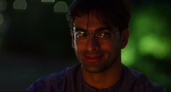 Movie still from “Monsoon Wedding” (2001), directed by Mira Nair – A person wearing glasses; Close Up shot, Low angle