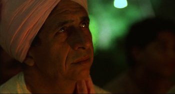 Movie still from “Monsoon Wedding” (2001), directed by Mira Nair – An older man with a towel on his head; Close Up shot, Over the shoulder angle