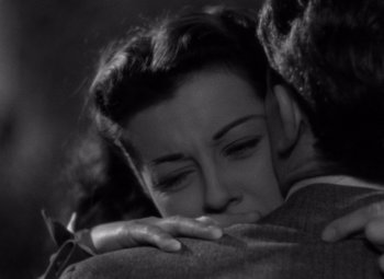 Movie still from “Moonrise” (1948), directed by Frank Borzage – A woman is hugging a man in a suit; Close Up shot, High angle