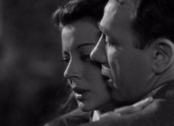 Movie still from “Moonrise” (1948), directed by Frank Borzage – A man and a woman face to face in a black and white photo; Close Up shot, High angle