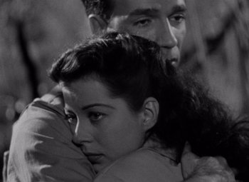 Movie still from “Moonrise” (1948), directed by Frank Borzage – A man and a woman embracing each other in a black and white photo; Close Up shot, High angle