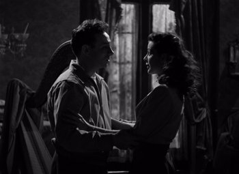 Movie still from “Moonrise” (1948), directed by Frank Borzage – A man and a woman holding each other in a room; Medium shot, Low angle