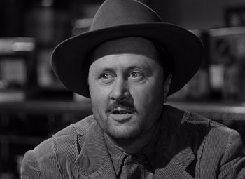 Movie still from “Moonrise” (1948), directed by Frank Borzage – A black and white photo of a man wearing a hat; Close Up shot, Low angle