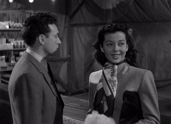 Movie still from “Moonrise” (1948), directed by Frank Borzage – A man and a woman standing next to each other; Medium shot, Low angle