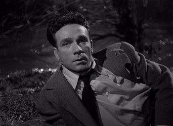 Movie still from “Moonrise” (1948), directed by Frank Borzage – A black and white photo of a man in a suit and tie; Close Up shot, High angle