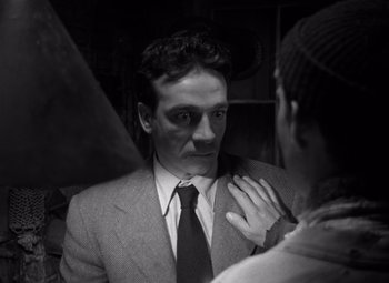 Movie still from “Moonrise” (1948), directed by Frank Borzage – A black and white photo of a man in a suit and tie; Close Up shot, Over the shoulder angle