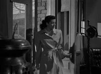 Movie still from “Moonrise” (1948), directed by Frank Borzage – An old photo of a woman in a trench coat; Medium shot, Low angle