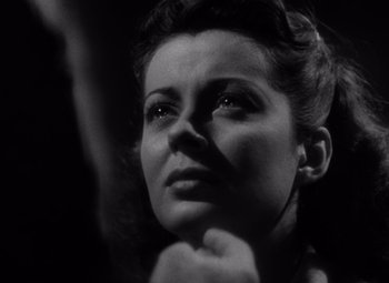 Movie still from “Moonrise” (1948), directed by Frank Borzage – A black - and - white photo of a woman looking up; Close Up shot, Low angle