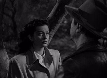 Movie still from “Moonrise” (1948), directed by Frank Borzage – An old photo of a man and a woman talking to each other; Close Up shot, High angle