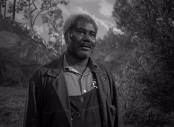 Movie still from “Moonrise” (1948), directed by Frank Borzage – A black and white photo of a man in a field; Medium shot, Low angle