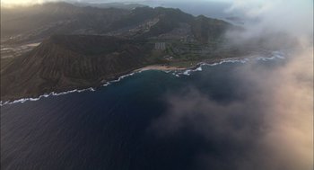 Movie still from “Morning Light” (2008), directed by Mark Monroe – An aerial view of the ocean and a beach; Extreme Wide shot, High angle