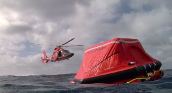 Movie still from “Morning Light” (2008), directed by Mark Monroe – A helicopter is flying over an inflatable boat; Extreme Wide shot, Low angle