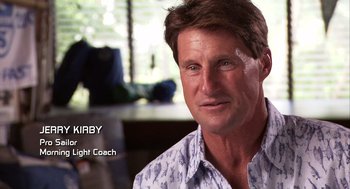 Movie still from “Morning Light” (2008), directed by Mark Monroe – A person wearing a shirt; Close Up shot, Over the shoulder angle