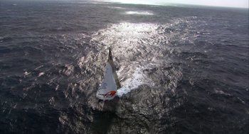 Movie still from “Morning Light” (2008), directed by Mark Monroe – An aerial view of a sailboat in the water; Extreme Wide shot, Overhead angle