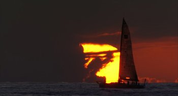 Movie still from “Morning Light” (2008), directed by Mark Monroe – A sail boat sailing on a body of water at sunset; Extreme Wide shot, Low angle