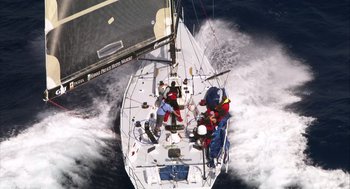 Movie still from “Morning Light” (2008), directed by Mark Monroe – A group of people riding on the back of a sail boat; Extreme Wide shot, Overhead angle