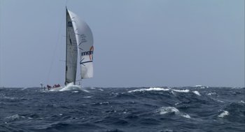Movie still from “Morning Light” (2008), directed by Mark Monroe – A sailboat in the middle of the ocean; Extreme Wide shot, Low angle