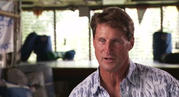 Movie still from “Morning Light” (2008), directed by Mark Monroe – A person wearing a shirt; Close Up shot, Low angle