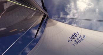 Movie still from “Morning Light” (2008), directed by Mark Monroe – A view of the sail of a sail boat under a cloudy sky; Extreme Wide shot, Low angle