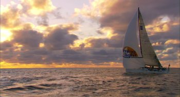Movie still from “Morning Light” (2008), directed by Mark Monroe – A sailboat sailing on the ocean under a cloudy sky; Extreme Wide shot, Low angle