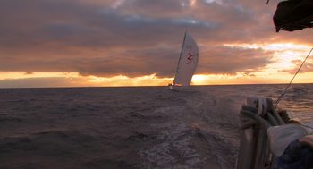 Movie still from “Morning Light” (2008), directed by Mark Monroe – A sailboat sailing on the ocean at sunset; Extreme Wide shot, Low angle