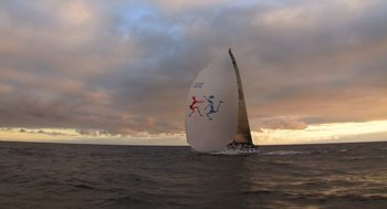 Movie still from “Morning Light” (2008), directed by Mark Monroe – A sailboat sailing on a body of water under a cloudy sky; Extreme Wide shot, High angle
