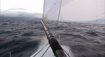 Movie still from “Morning Light” (2008), directed by Mark Monroe – A sailboat sailing on the open water; Extreme Wide shot, High angle