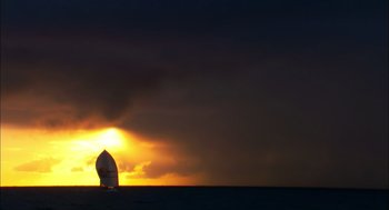 Movie still from “Morning Light” (2008), directed by Mark Monroe – A sailboat in the middle of the ocean under a cloudy sky; Extreme Wide shot, Low angle