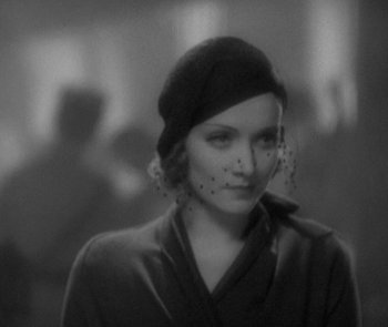 Movie still from “Morocco” (1930), directed by Josef von Sternberg – A black and white photo of a woman wearing a hat; Close Up shot, Over the shoulder angle