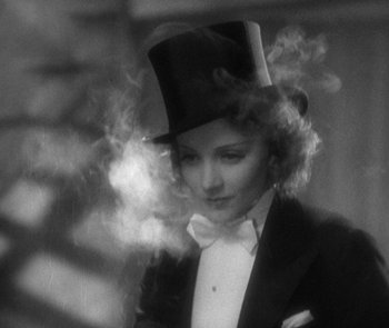 Movie still from “Morocco” (1930), directed by Josef von Sternberg – A black and white photo of a woman wearing a top hat; Close Up shot, Low angle