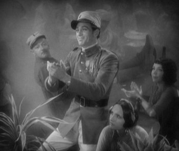 Movie still from “Morocco” (1930), directed by Josef von Sternberg – A man in a military uniform holding a whip; Wide shot, High angle