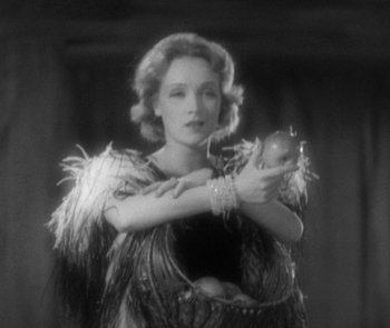 Movie still from “Morocco” (1930), directed by Josef von Sternberg – An old photo of a woman holding an animal; Medium shot, Low angle