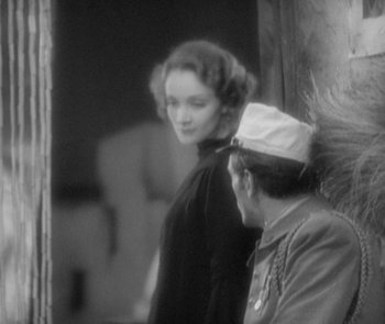 Movie still from “Morocco” (1930), directed by Josef von Sternberg – An old photo of a man and a woman looking at each other; Medium shot, Over the shoulder angle