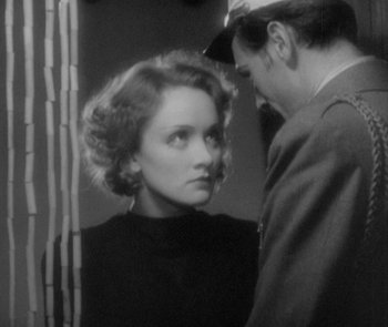 Movie still from “Morocco” (1930), directed by Josef von Sternberg – An old photo of a woman and a man looking at each other; Close Up shot, Over the shoulder angle