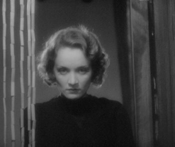 Movie still from “Morocco” (1930), directed by Josef von Sternberg – A black and white photo of a woman in front of a mirror; Close Up shot, Low angle