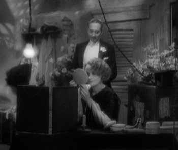 Movie still from “Morocco” (1930), directed by Josef von Sternberg – A man and a woman are looking in a mirror; Medium shot, Over the shoulder angle