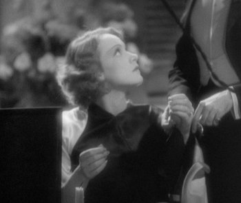 Movie still from “Morocco” (1930), directed by Josef von Sternberg – An old photo of a woman looking up at something; Close Up shot, Low angle