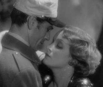 Movie still from “Morocco” (1930), directed by Josef von Sternberg – A man and a woman are kissing in a black - and - white photo; Close Up shot, High angle