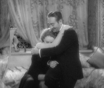 Movie still from “Morocco” (1930), directed by Josef von Sternberg – A man and a woman hugging each other in front of a couch; Medium shot, High angle