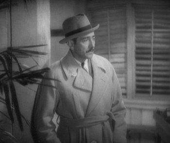 Movie still from “Morocco” (1930), directed by Josef von Sternberg – A man wearing a hat and a trench coat; Medium shot, High angle