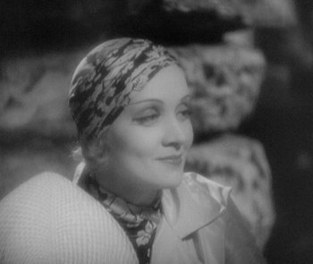 Movie still from “Morocco” (1930), directed by Josef von Sternberg – An old photo of a woman wearing a head scarf; Close Up shot, High angle