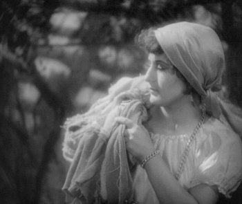 Movie still from “Morocco” (1930), directed by Josef von Sternberg – An old photo of a woman holding a blanket; Close Up shot, High angle