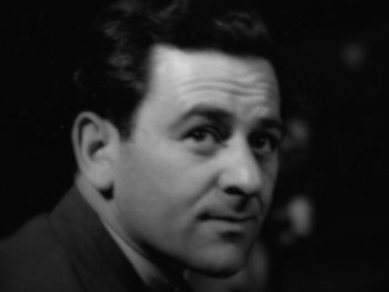 Movie still from “Five Came Back” (2017), directed by Laurent Bouzereau – An old black and white photo of a man in a suit; Close Up shot, High angle