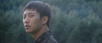 Movie still from “Mother” (2009), directed by Bong Joon Ho – A person wearing a black shirt; Close Up shot, Low angle